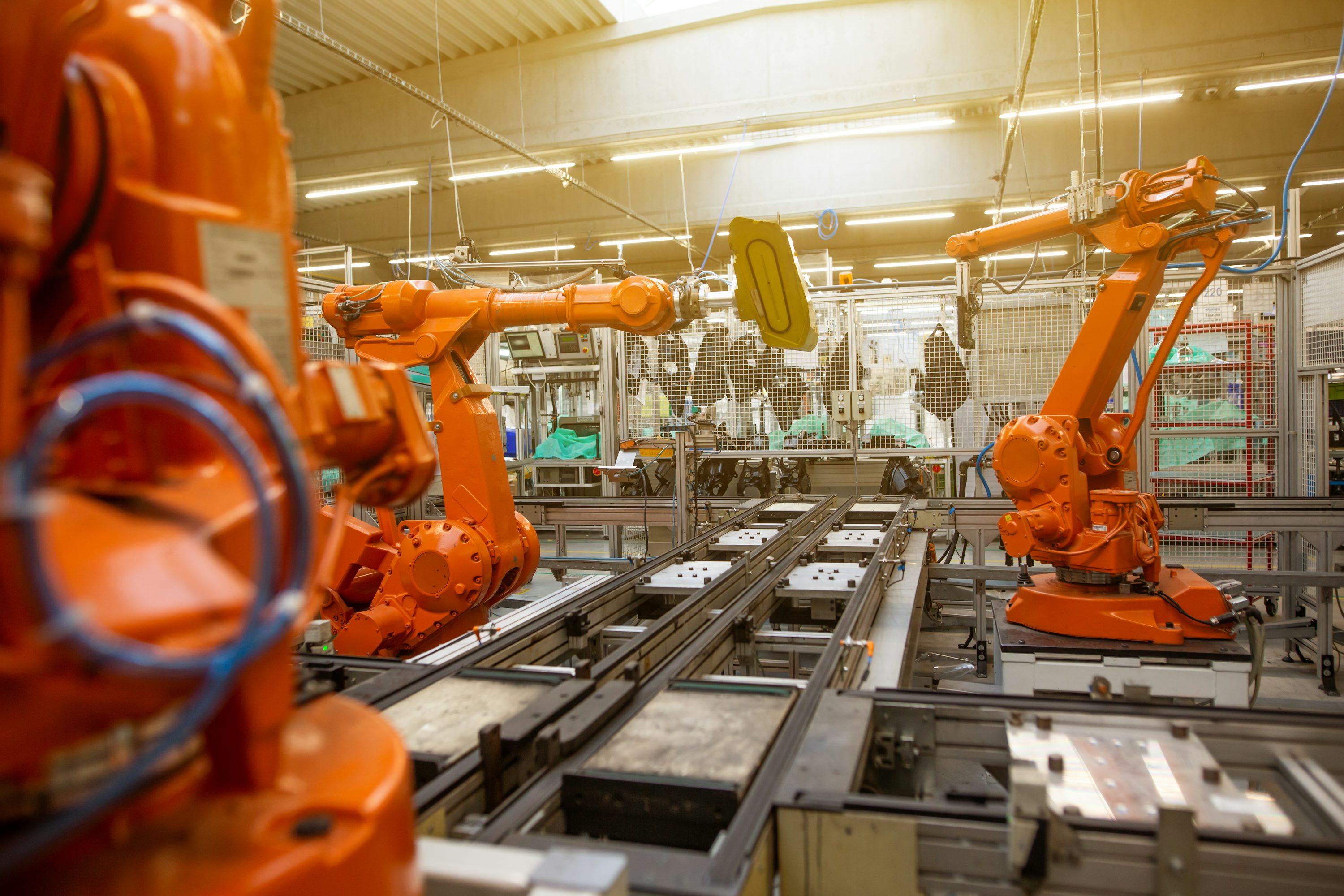 Industrial robotic arms on an assembly line